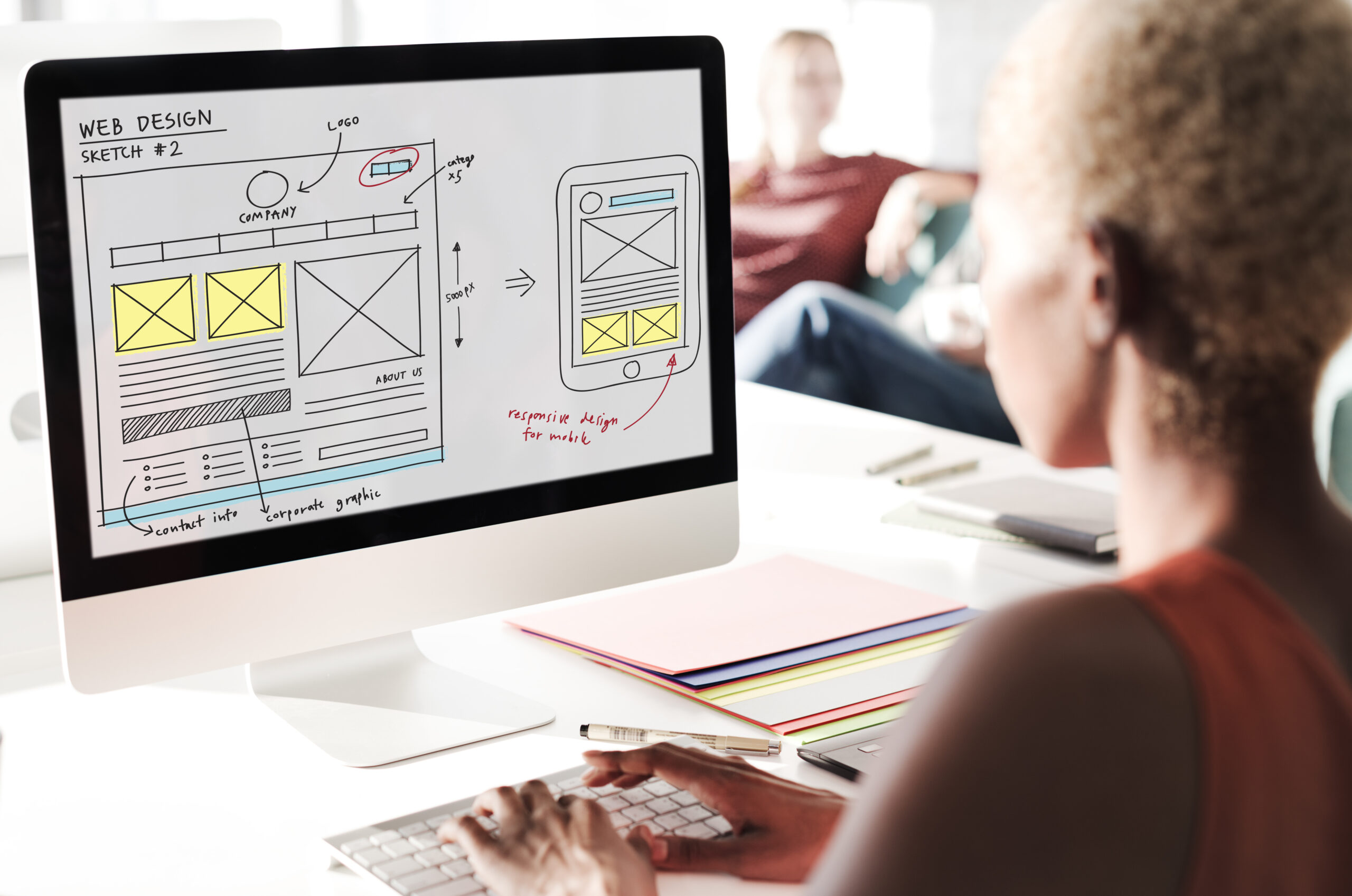 A women making a website redesign plan on her computer.
