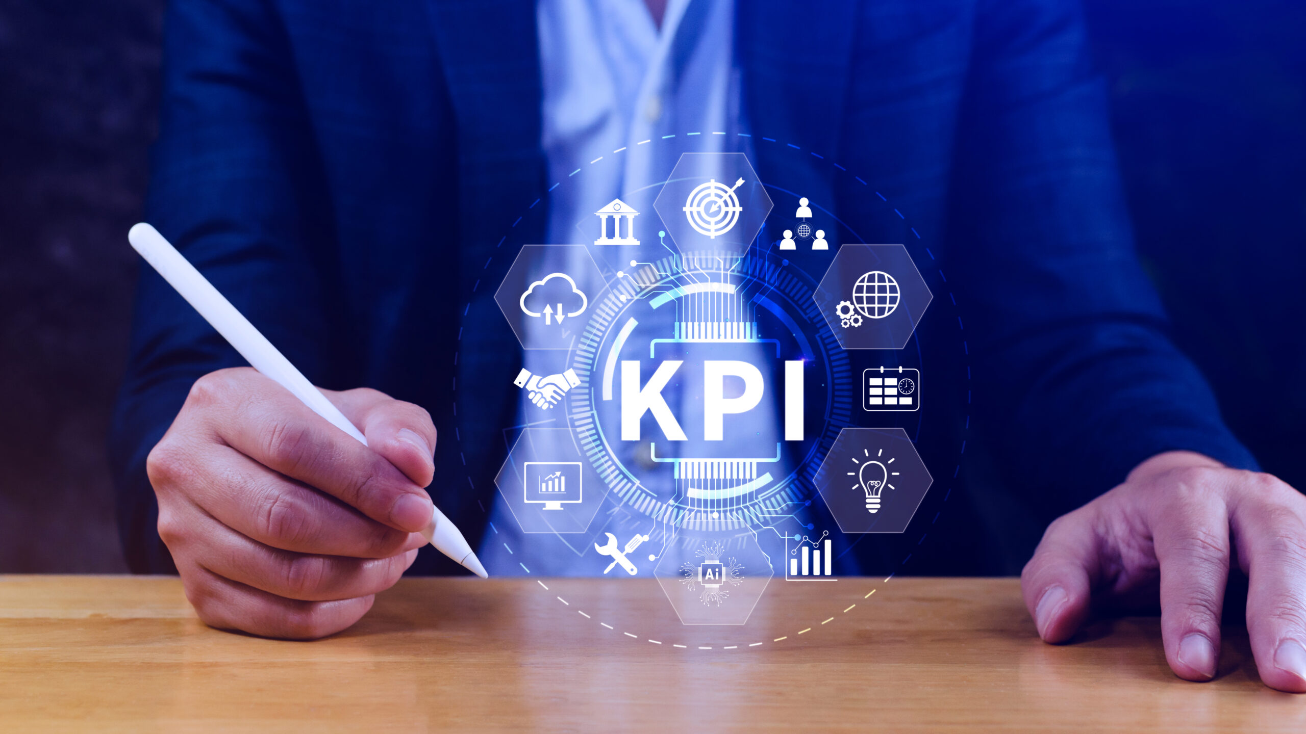 Business professional using a digital pen to interact with a virtual KPI (Key Performance Indicator) interface, displaying icons for analytics, target setting, teamwork, global connectivity, and business performance metrics.