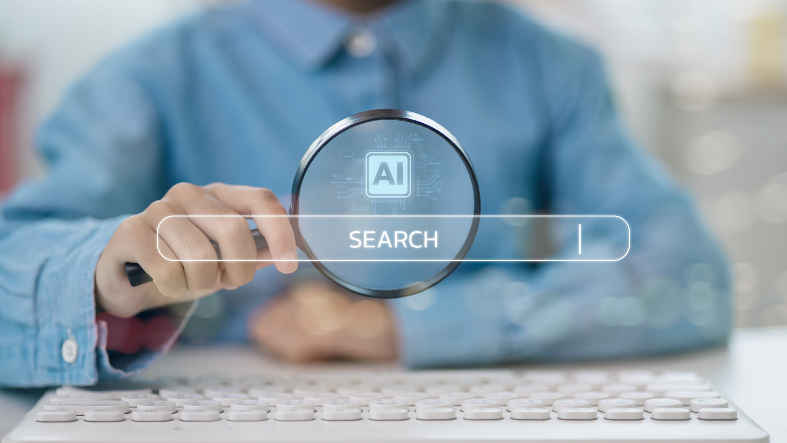 Man in a blue shirt holding up a magnifying glass to a holographic search bar that says AI search, indicating AI SEO.